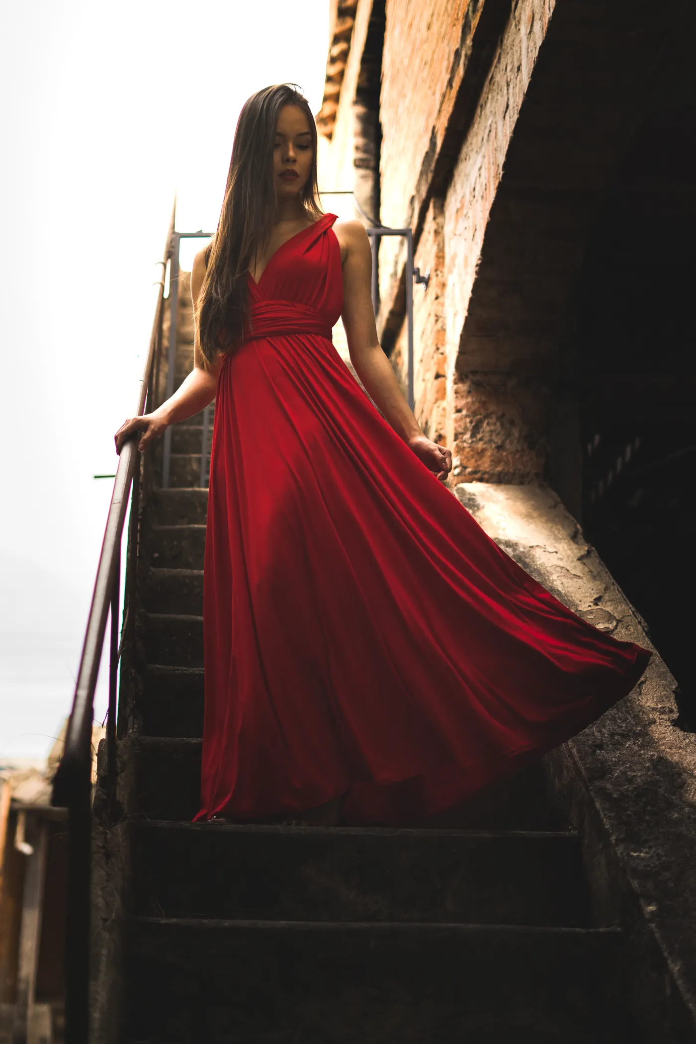 Model walking on a fashion runway under dramatic lights